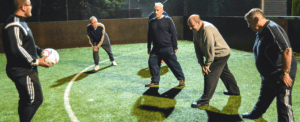 Men stretching before playing football